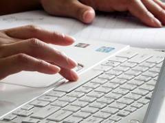 hands typing on laptop